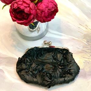 Black clutch with Rosette embellishments & strap.